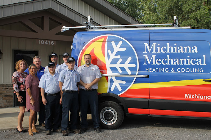 why-choose-michiana-mechanical Michiana Mechanical heating and cooling team standing beside branded service van outside office in Northwest Indiana